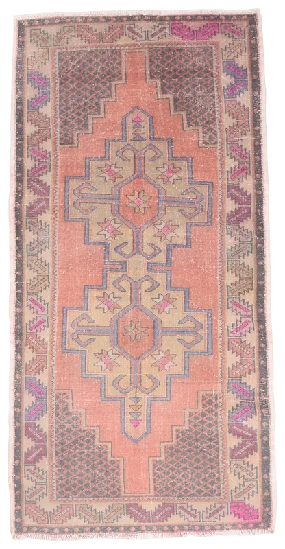 Top view of the 3'10" x 7'10" vintage Anatolian area rug with rust, beige, and brown geometric patterns