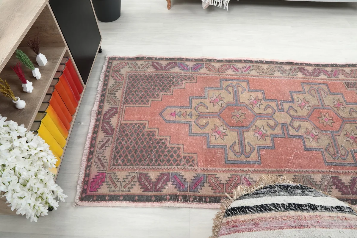 Wide angled view of the rug on the floor, capturing the full length and its interaction with the room