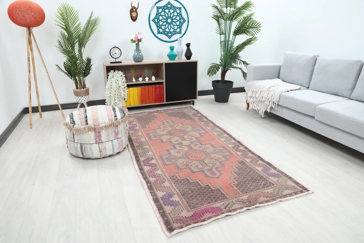 Angled view of the rust and beige geometric rug in a room setting, highlighting its placement
