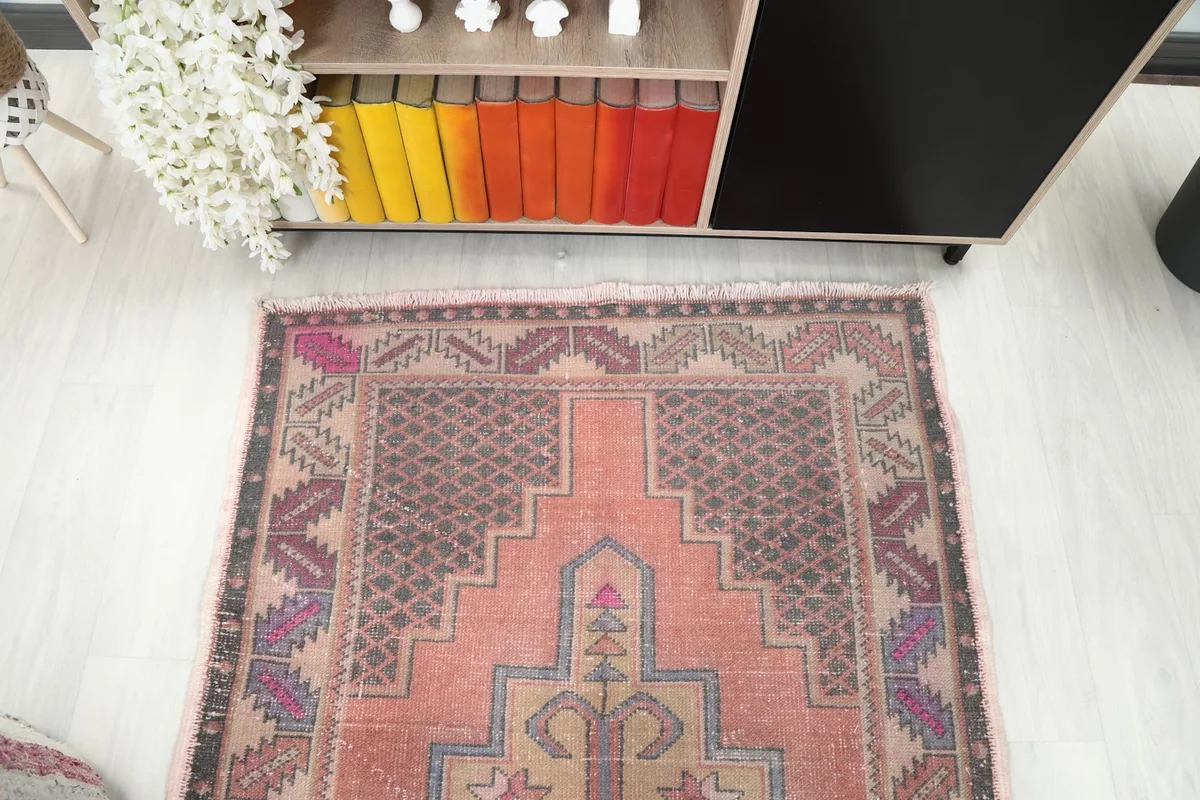 Overhead view focusing on the upper half of the rug, displaying the full width of the pattern