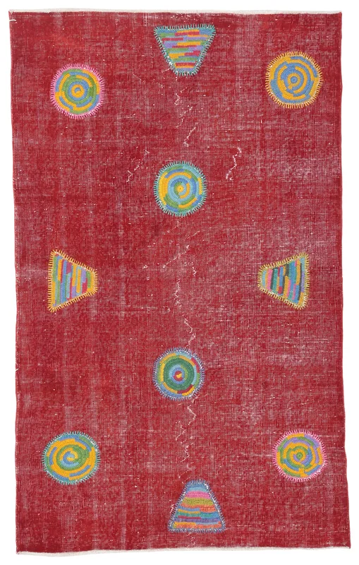 Full top view of the 3'11" x 6'7" vintage Anatolian rug with a red field and colorful geometric patches
