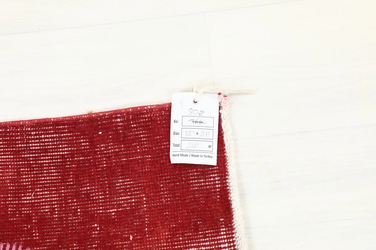 Close-up of the product tag attached to the rug, indicating its origin and material