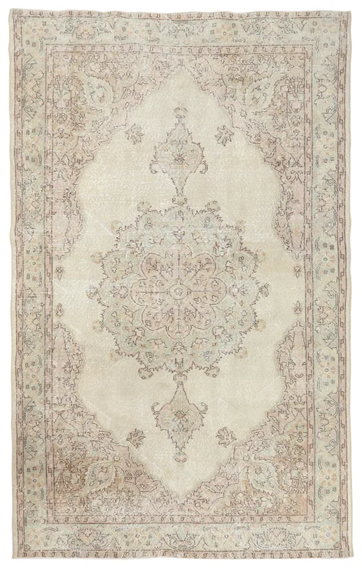 Full top view of the soft ivory vintage Anatolian area rug with a central medallion on a white background
