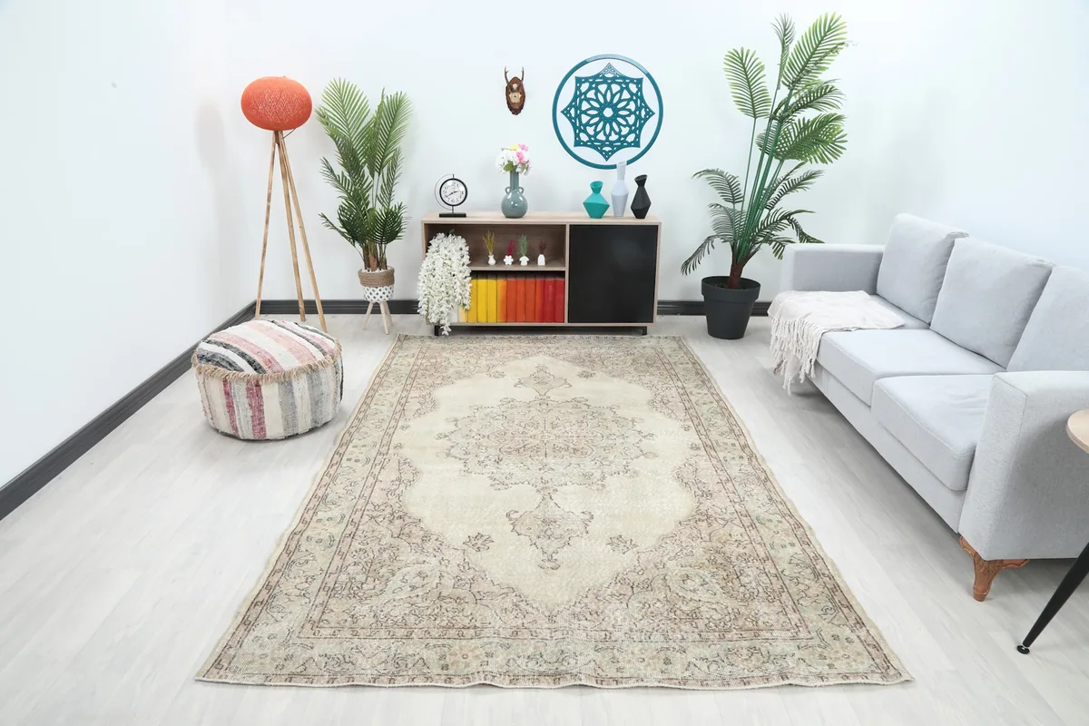 Vintage Anatolian rug displayed in a living room setting, showing its overall size and placement
