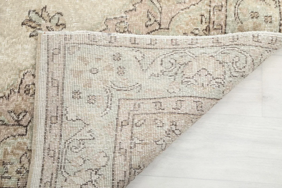Close-up of the rug's underside, showing the tightly woven cotton foundation and knotting