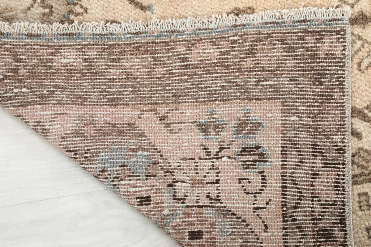 Close-up of the back of the rug, showcasing the tight hand-knotting on a cotton foundation.