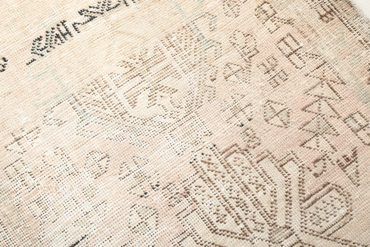 Detailed view of the hand-knotted wool pile and intricate geometric weaving