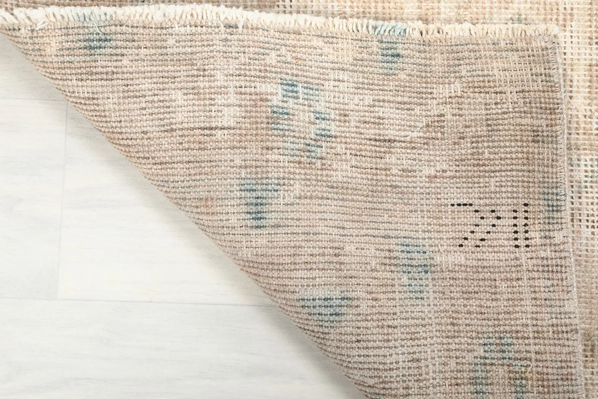 Underside of the hand-knotted rug, revealing the cotton foundation and knotting