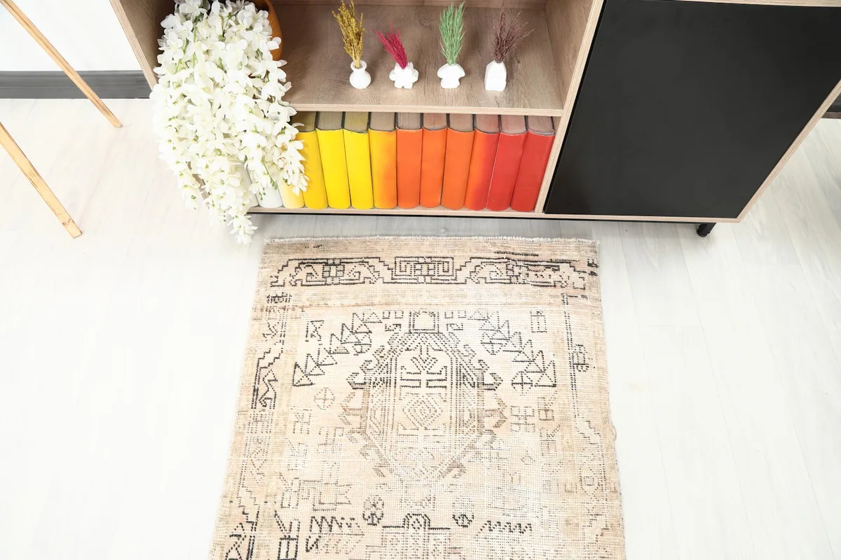 Top-down detail of the runner rug's geometric motifs and beige field