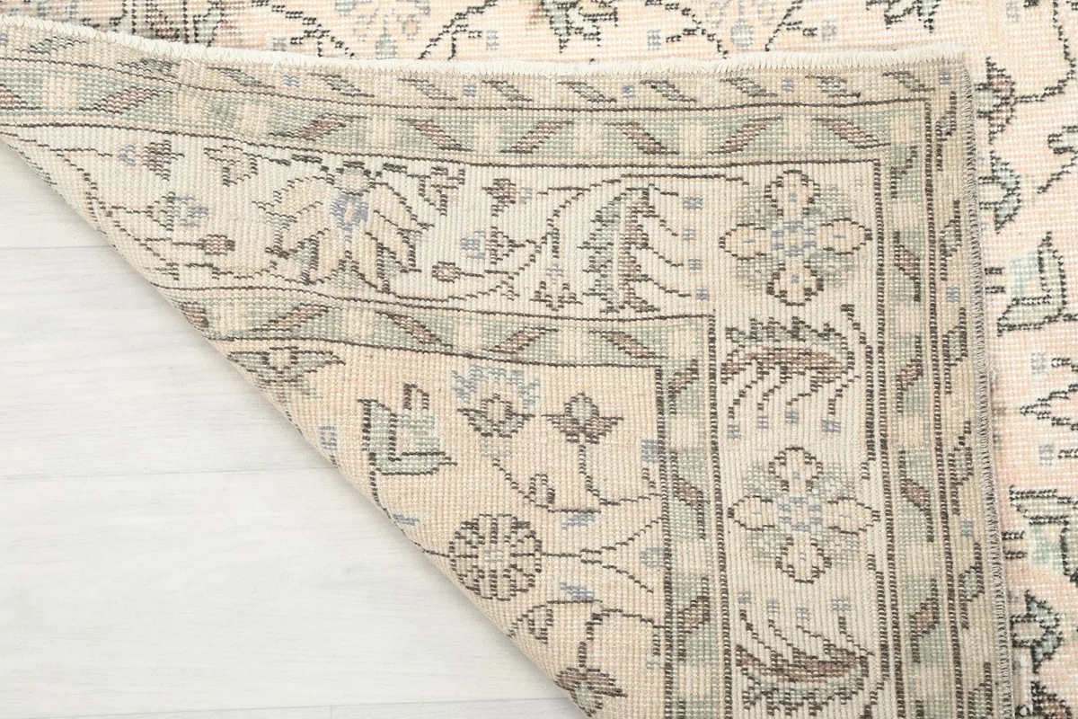 Close-up of the back of the rug, revealing the hand-knotted construction and cotton foundation.