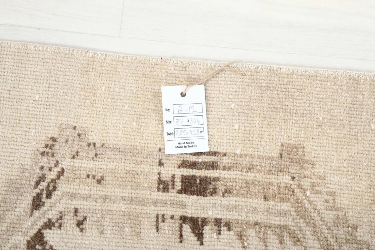 Close-up of the rug's corner with the product tag, showing origin as hand-made in Turkey.