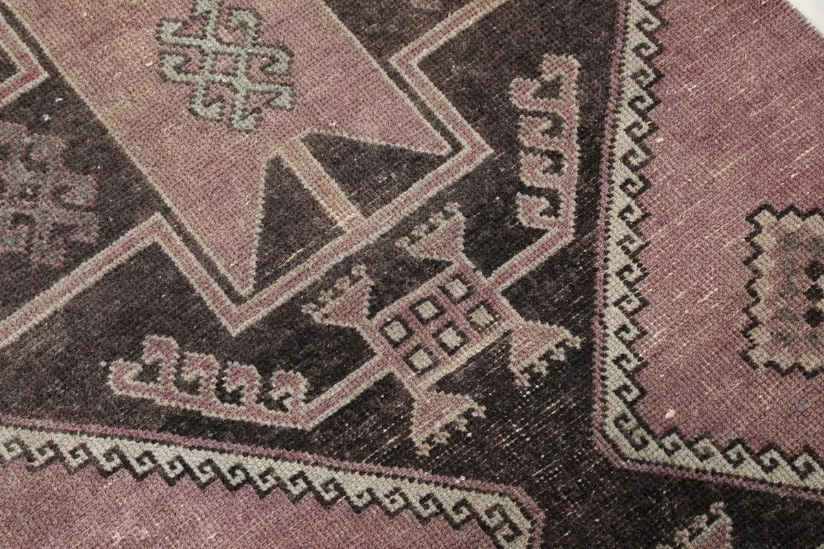 Close-up of the tribal geometric patterns and border details on the runner rug