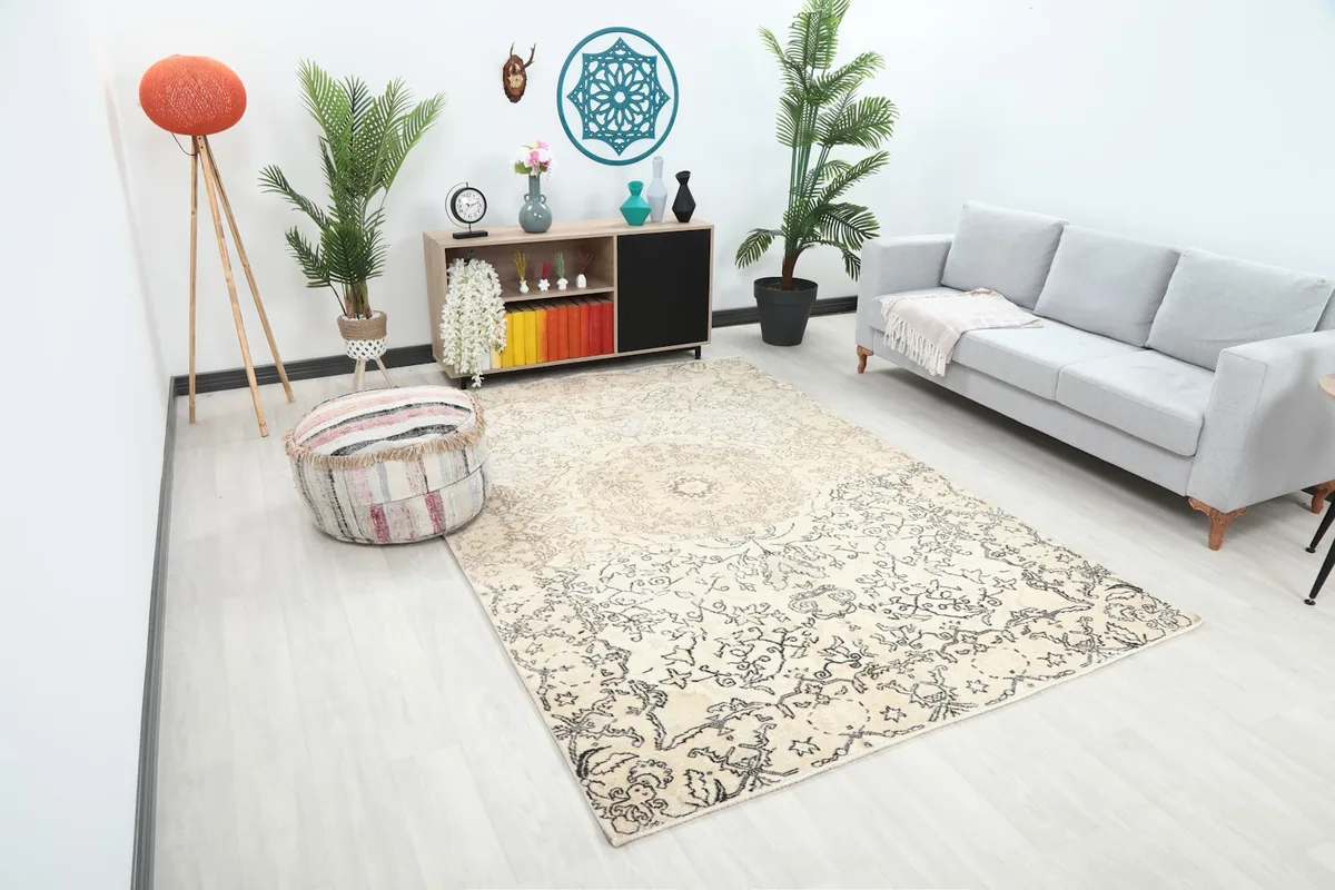 Angle view of the ivory and charcoal vintage rug in a living room, showing its size relative to furniture