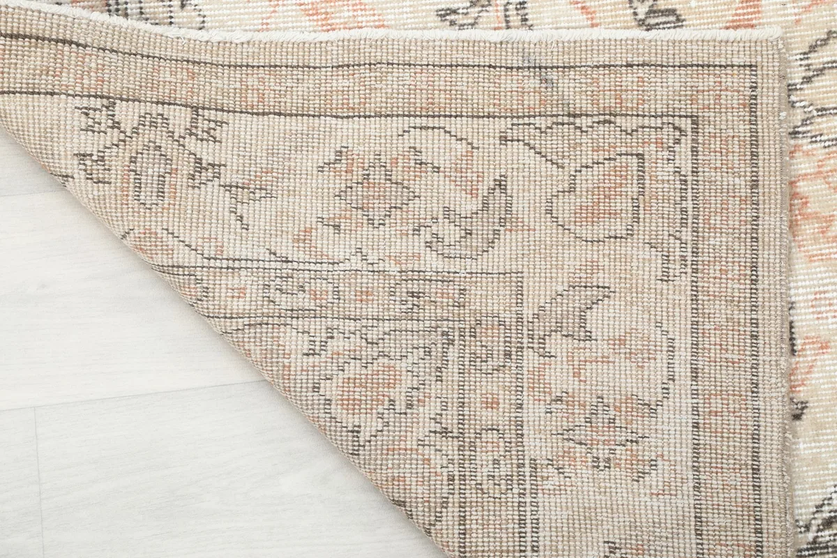 View of the rug's backside, showing the tight hand-knotting and foundation