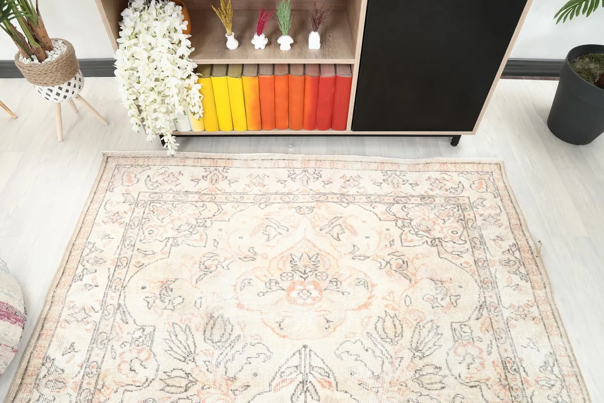Overhead perspective of the vintage rug, highlighting its central medallion and border