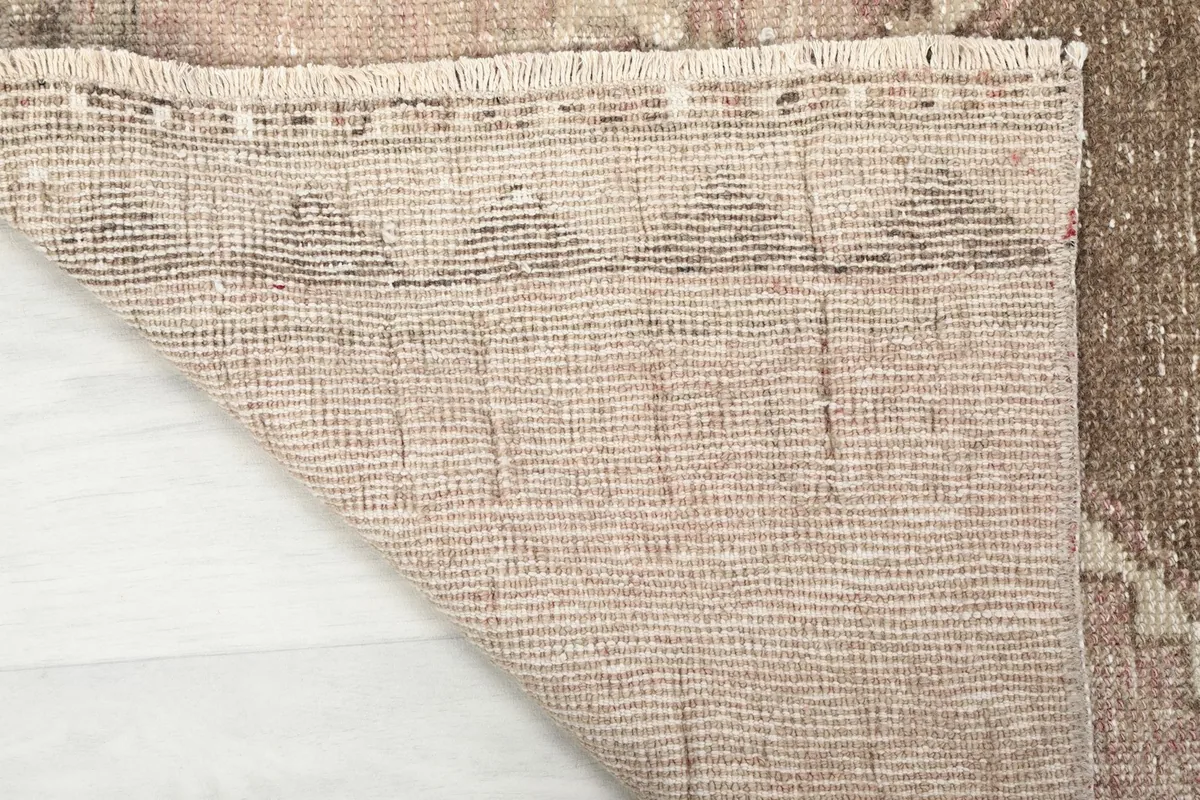Underside view of the runner, displaying the hand-knotted cotton foundation and weave structure