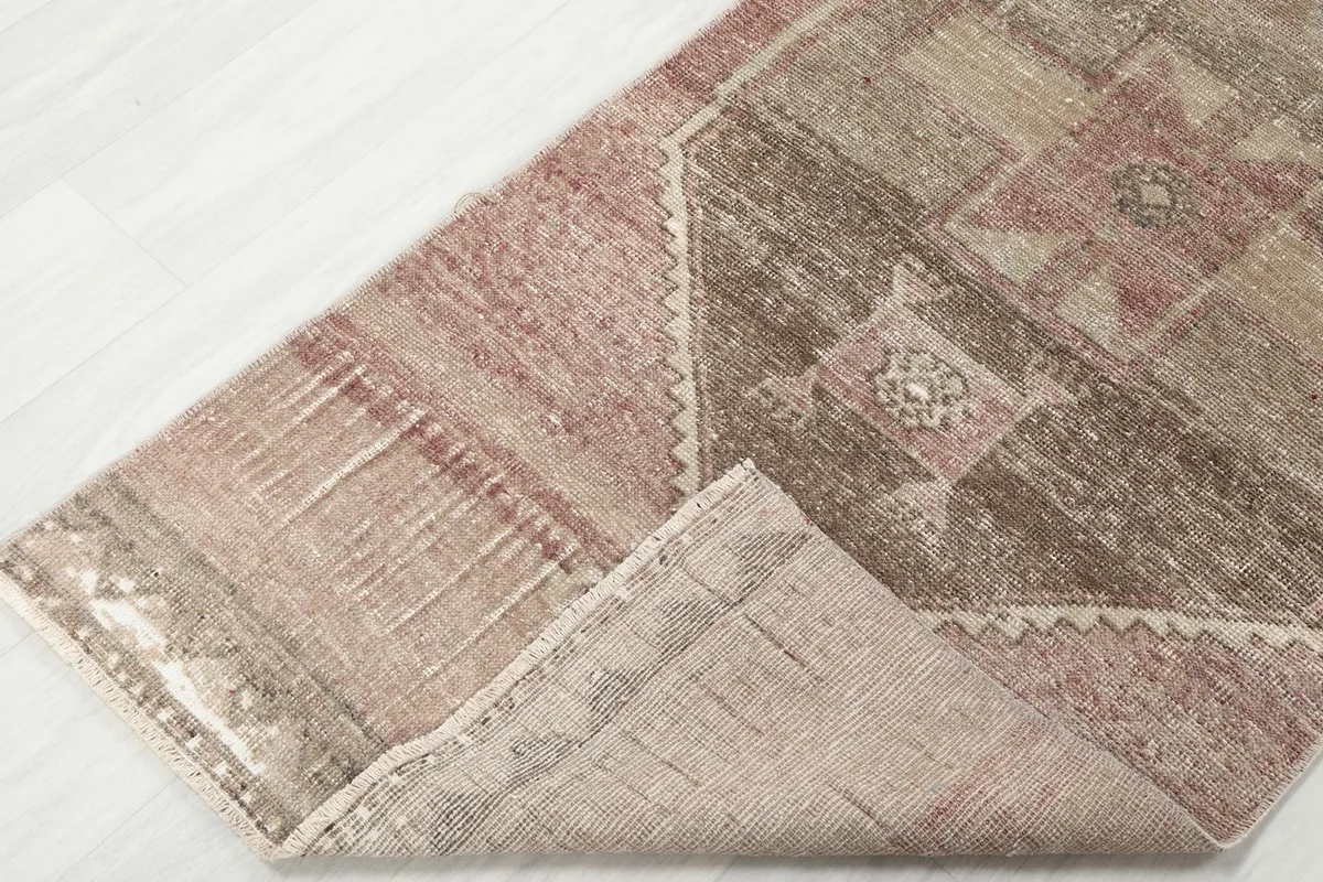Corner of the runner folded to show the wool pile on the cotton foundation and construction