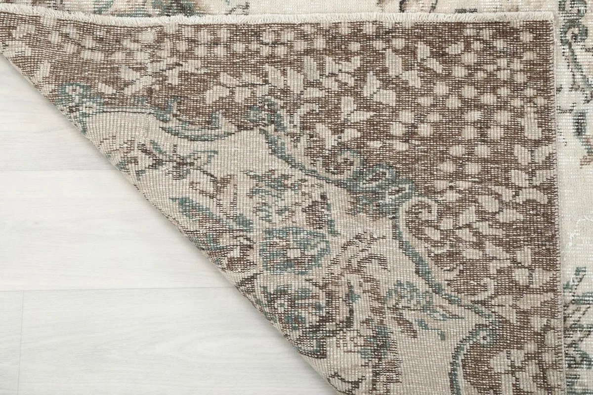 Underside of the rug showing the hand-knotted wool pile on a cotton foundation