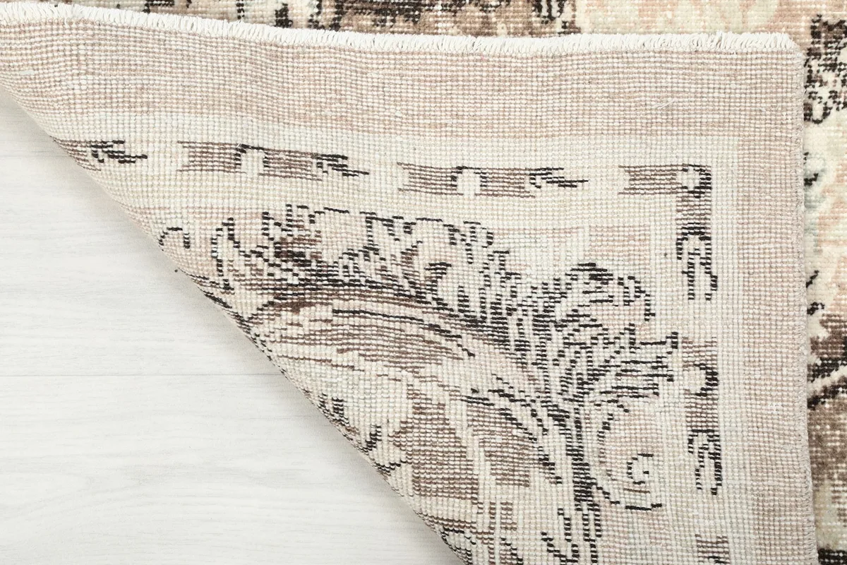 Close-up of the rug's reverse side, illustrating the hand-knotted construction and cotton foundation.
