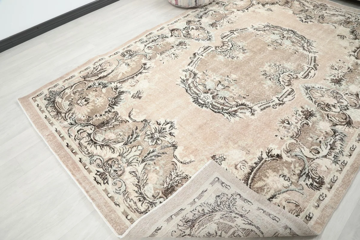 View of the rug with a corner folded back, showing the cotton foundation and reverse side.
