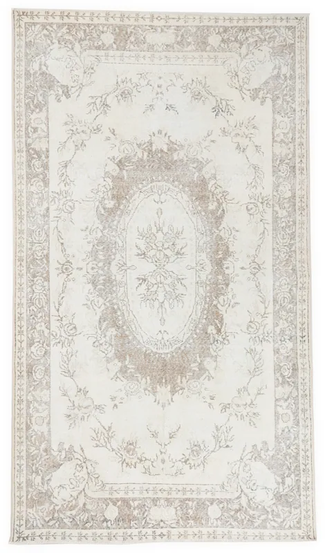 Full top view of the ivory and beige floral medallion vintage Anatolian rug on a white background