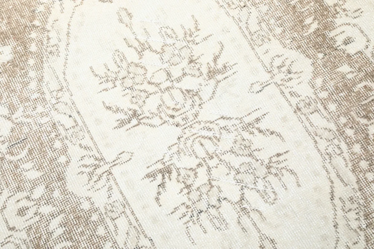 Close-up of the intricate floral motifs within the central part of the rug