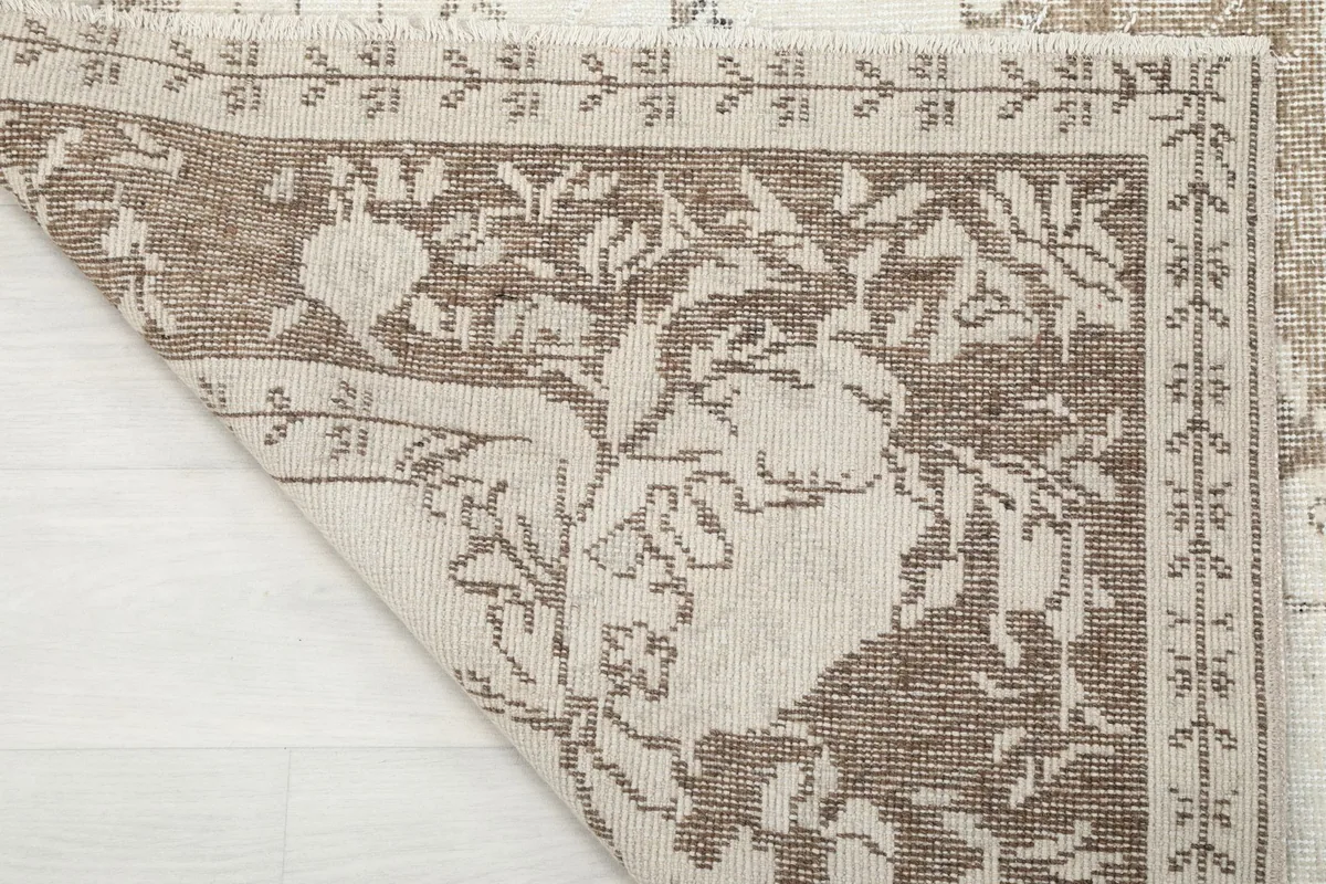 Close-up of the back of the rug, showing the wool pile and cotton foundation