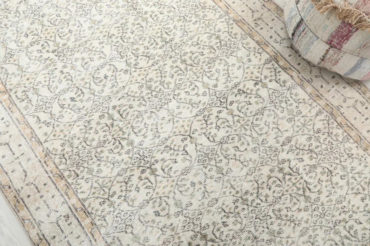 Detailed view of the intricate floral and geometric patterns on the rug