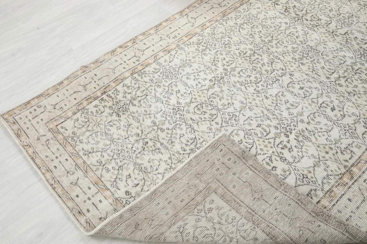 View of the rug folded back, showing the cotton foundation and reverse side
