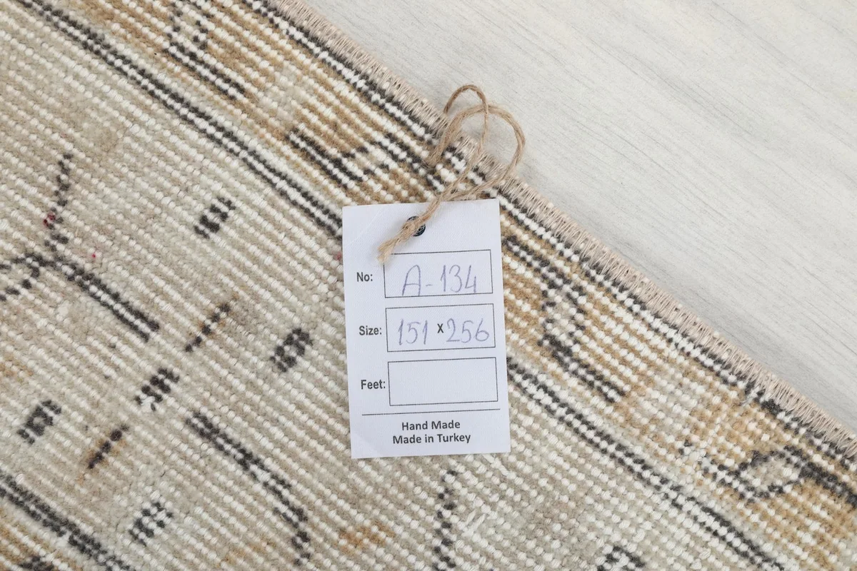 Tag showing rug number A-134 and size 151x256 cm on the back of the rug