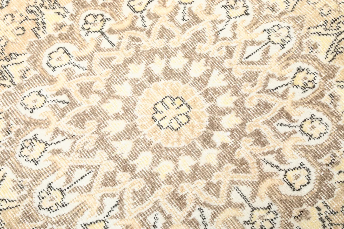 Detailed view of the wool pile texture and faded patterns, showing the vintage character of the rug.