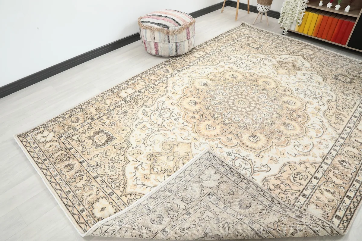 View of the rug with a corner folded back, revealing the cotton foundation and reverse side.