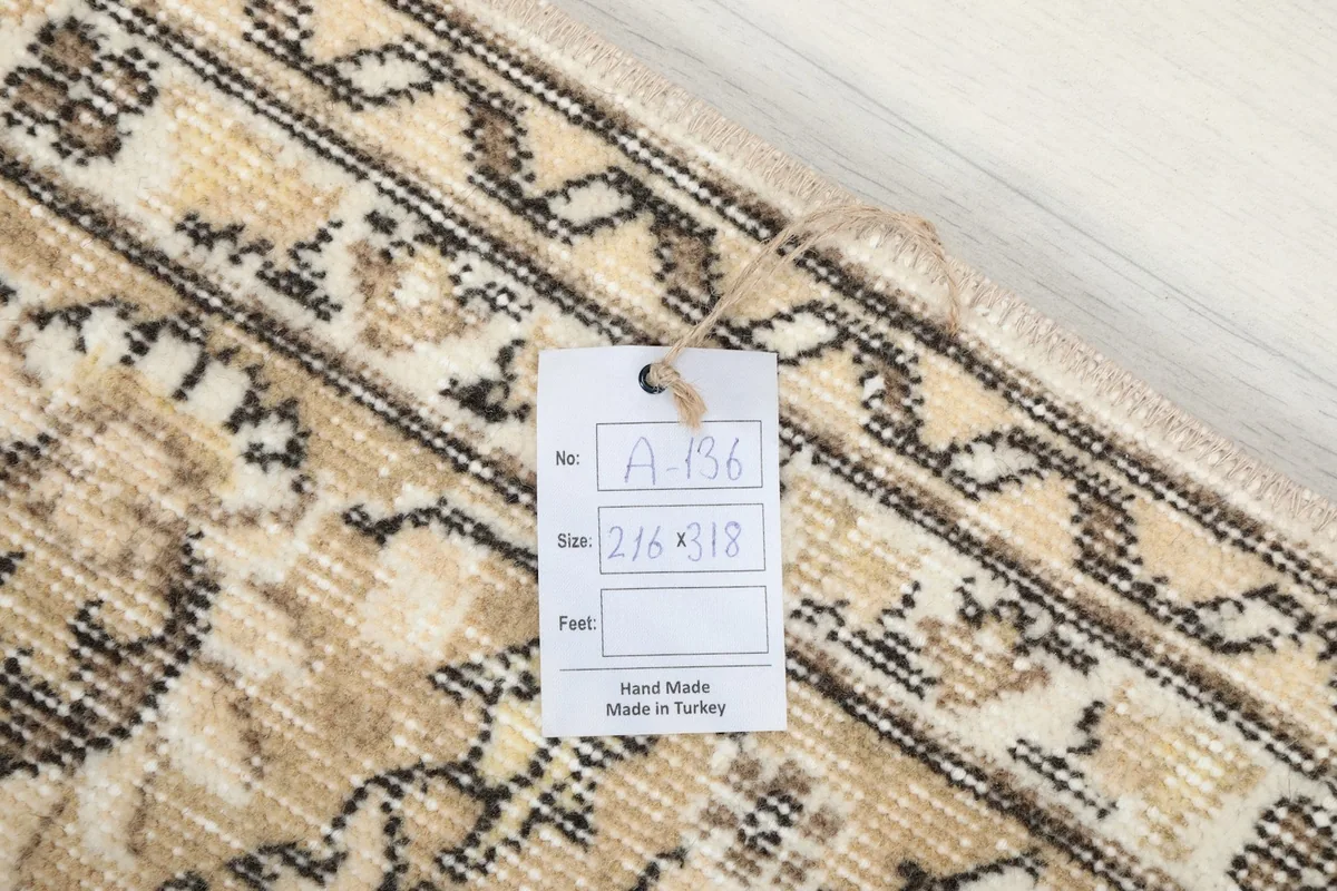 Product tag on the rug showing the dimensions 216 x 318 cm and "Hand Made in Turkey".
