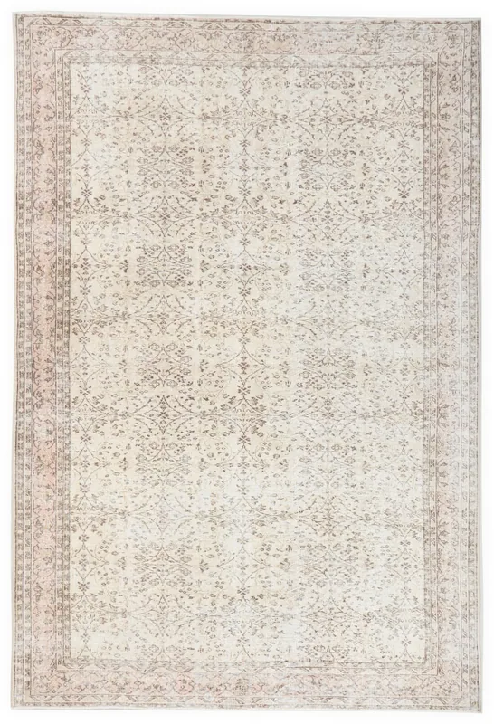 Full overhead view of the 6'11" x 9'5" vintage ivory and rose floral Anatolian rug