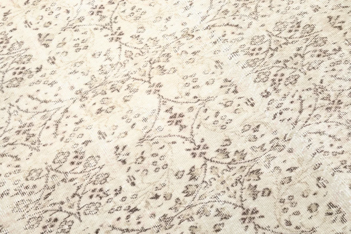 Close-up of the delicate floral patterns and texture of the hand-knotted wool pile