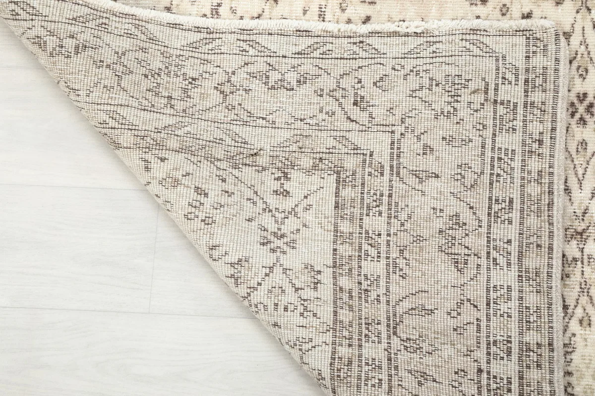 Underside of the rug showing the hand-knotted construction and foundation
