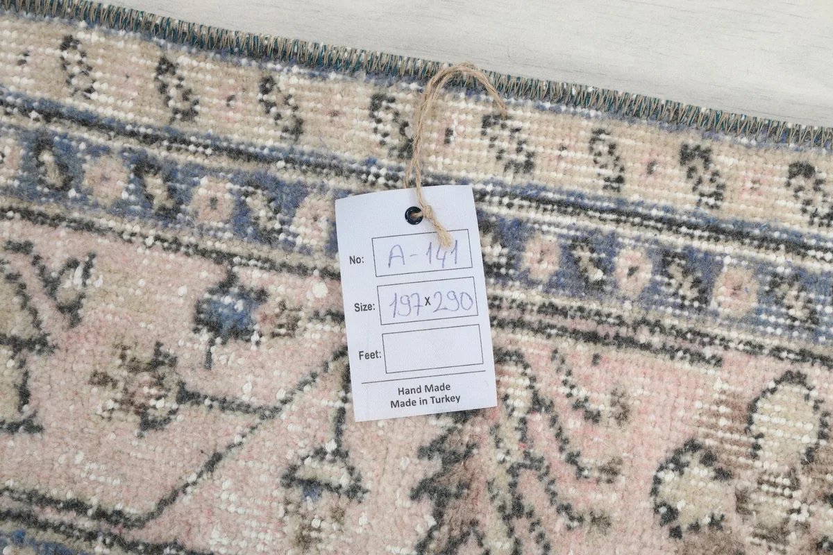 Product tag on the rug showing item number, size in centimeters, and 'Hand Made Made in Turkey'