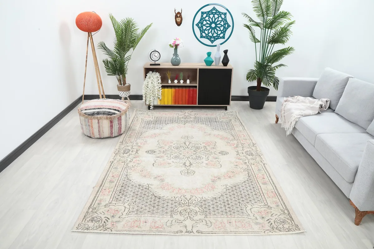 Vintage Anatolian rug in a living room setting, showing its size relative to a sofa