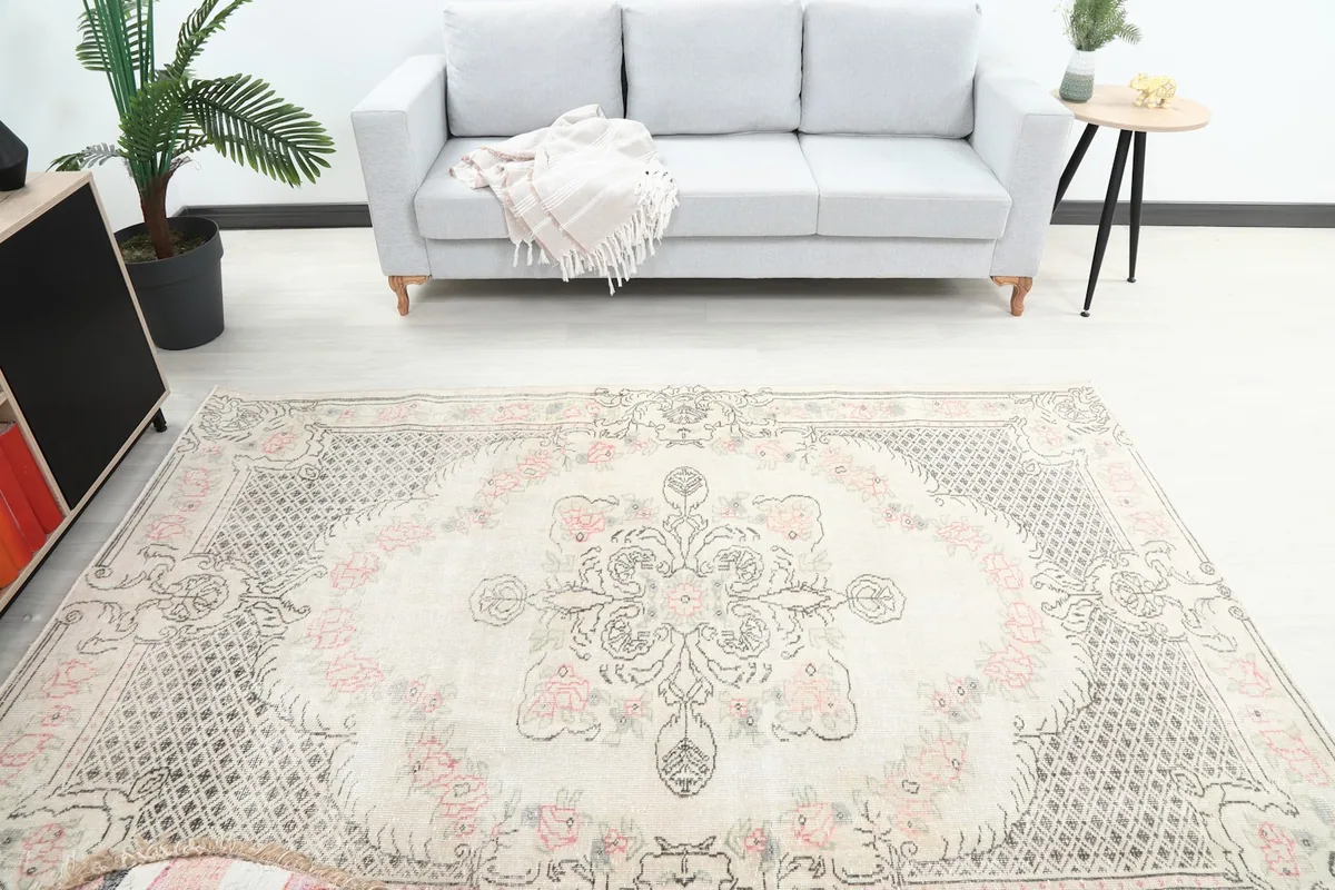 Overhead view of the rug centered in a room with a gray sofa and side table