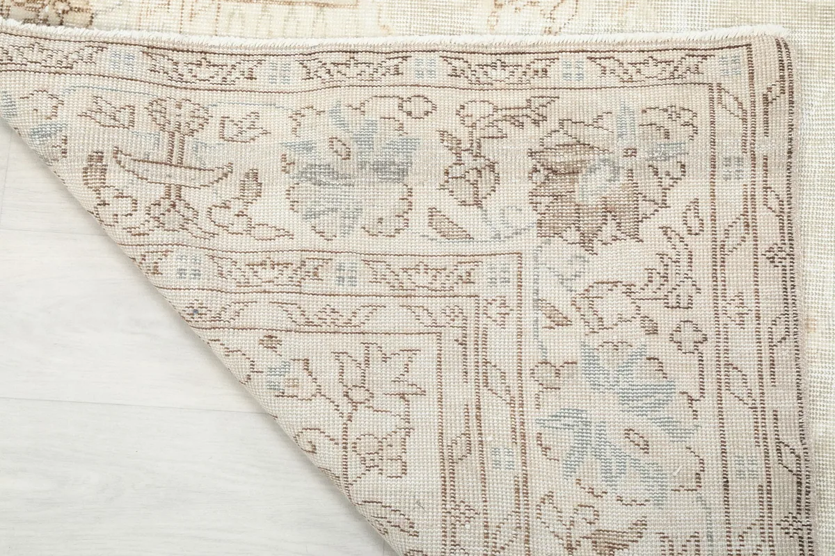 Close-up of the rug's backside, showing the tight hand-knotted cotton foundation