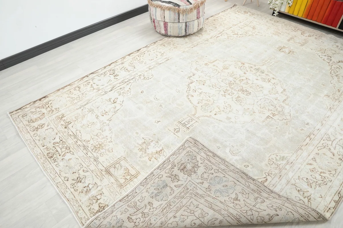 View of the rug with a corner folded back, revealing the reverse side and construction