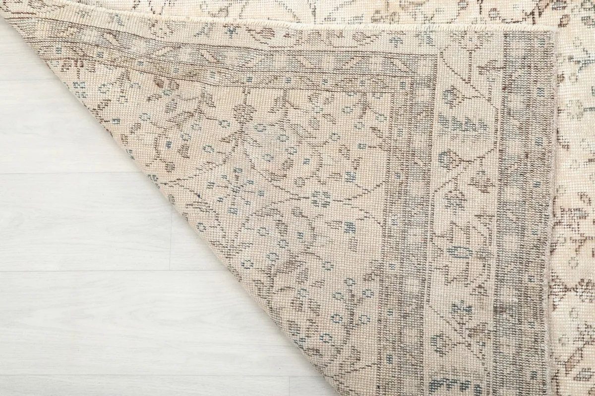 Close-up of the back of the hand-knotted rug, showing the cotton foundation and tight weave.