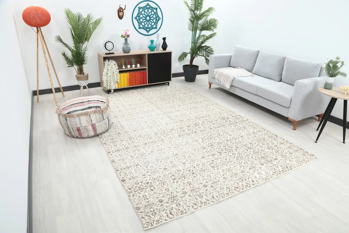 Angle view of the large ivory and brown floral rug in a contemporary living space