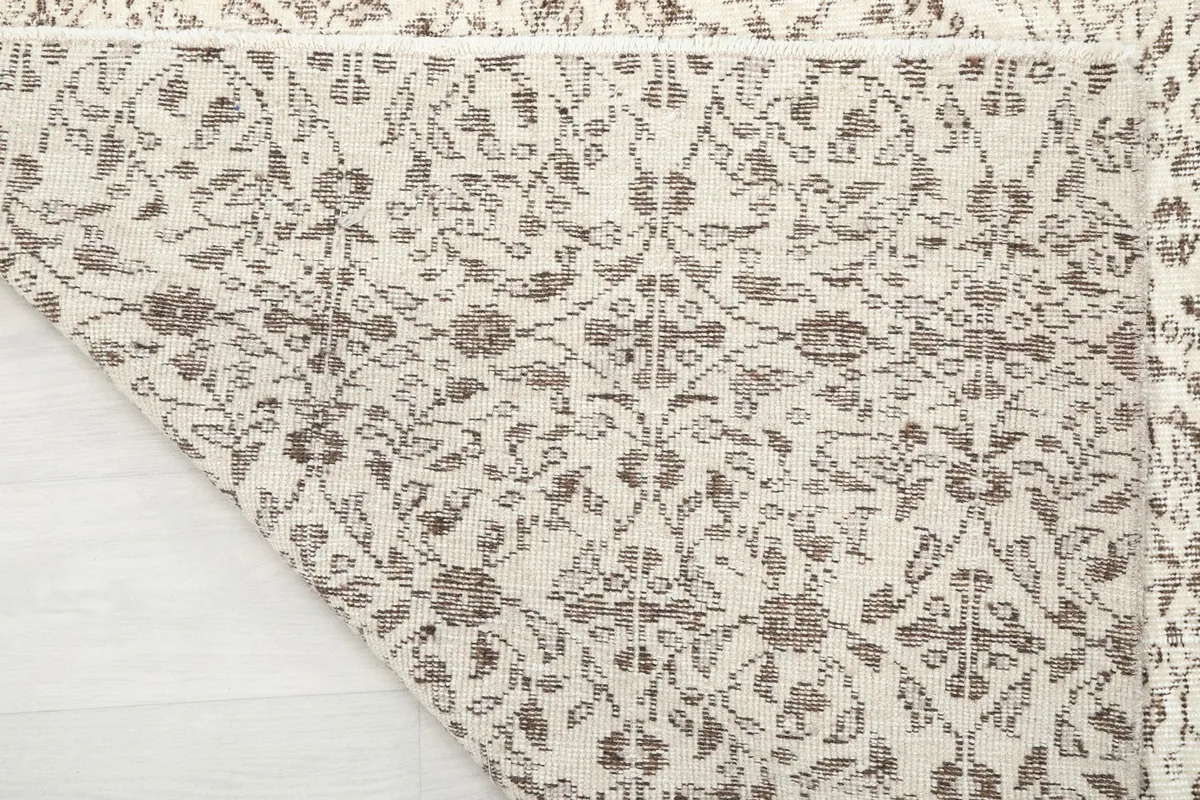 Close-up of a folded corner of the rug, revealing the woven texture and pattern