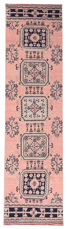 Full top view of the 3x11 rose and navy geometric Anatolian runner rug on a white background
