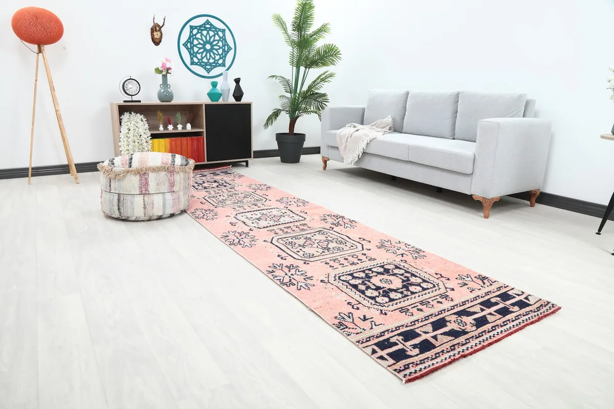 Angled view of the runner rug in a room, highlighting its length and geometric pattern