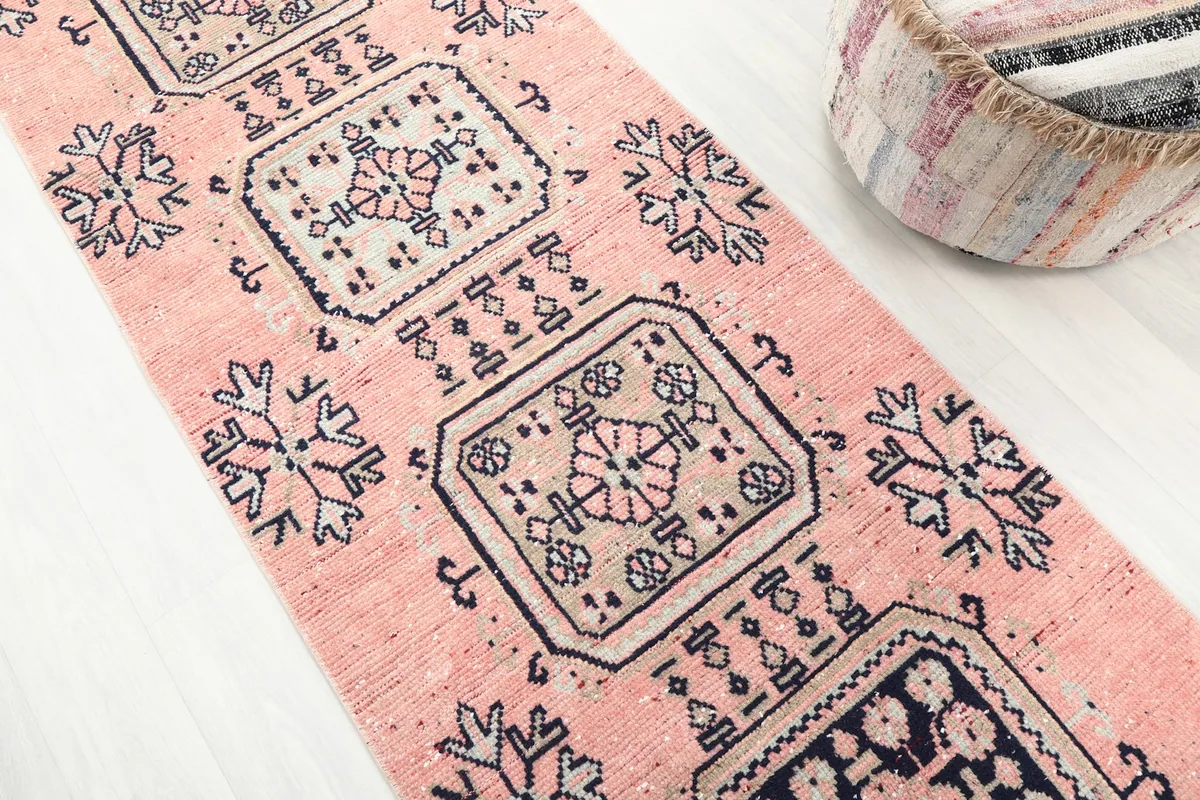 Detailed view of the rose field and geometric motifs on the hand-knotted runner