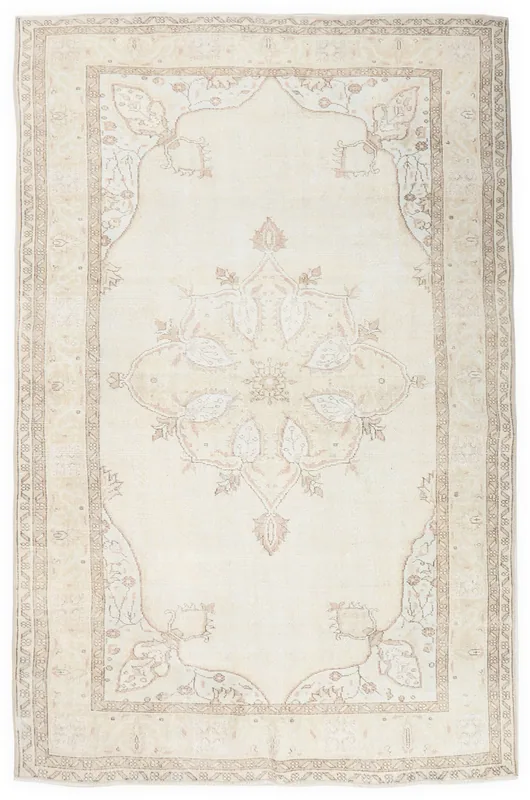 Full overhead view of the vintage cream Anatolian area rug with a floral medallion design