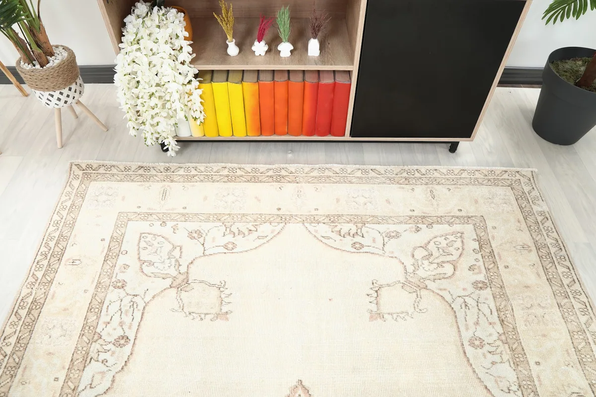 View of the cream rug's upper section and border, showcasing the design details