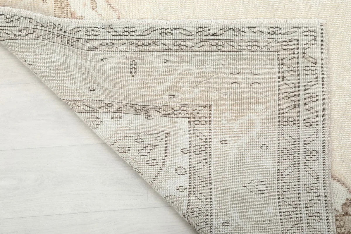 Underside of the hand-knotted vintage rug, showing the cotton foundation and knotting
